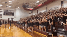 a large crowd of people in a gym with a sign that says bethel college on it