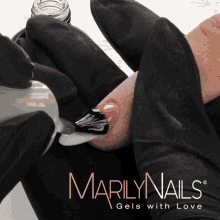 a bottle of marilyn nails gels with love is being applied to a finger