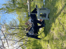 two people sit at a table in the grass