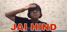 a man wearing headphones salutes with the words jai hind written above him