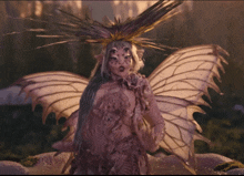 a woman dressed as a fairy with wings and a crown on her head