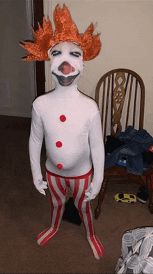 a person in a clown costume is standing next to a wooden chair .