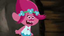 a troll with pink hair and a blue flower crown on her head