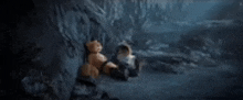 a couple of teddy bears are sitting next to each other in a dark cave .