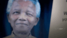 a close up of a man 's face with a sign in the background that says " i wish you "