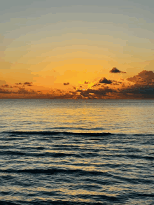 a sunset over a body of water with waves