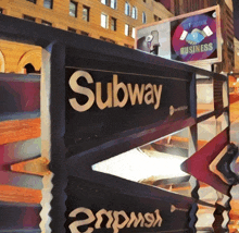 a sign that says subway on it in front of buildings