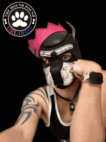 a man wearing a mask with the hound pound orlando logo