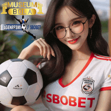 a woman is holding a soccer ball with the word sbobet on her shirt