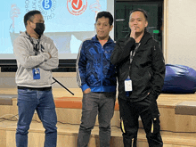 three men are standing in front of a screen that says ' nc security '