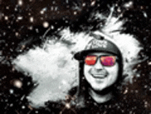 a man wearing sunglasses and a baseball cap is smiling in front of a galaxy .