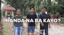 a group of young boys are standing in a park with the words handa na ba kayo written above them