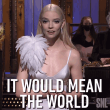 a woman in a white dress says it would mean the world on snl