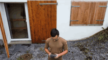 a man standing in front of a wooden door