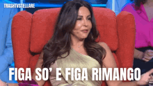 a woman in a gold dress is sitting in a red chair with the words figa so ' e figa rimango