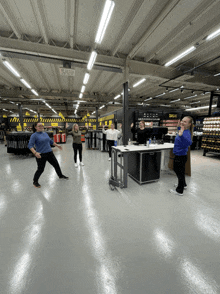 a group of people are standing in a room with a sign that says ' a.l.u.f.f. '