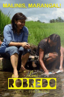 a poster for leni robredo shows two women kneeling in the water