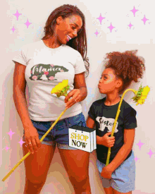 a woman and a little girl standing next to each other holding flowers and a shopping bag that says shop now