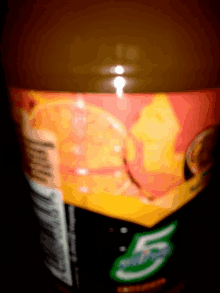 a bottle of orange soda with the number 5 on the side