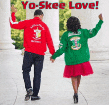 a man in a red kappa alpha psi jacket and a woman in a green kappa alpha psi jacket holding hands