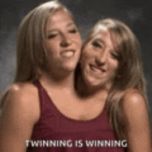 two women are standing next to each other and smiling with the words winning is winning on the bottom .