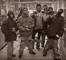 a group of young men standing next to each other in a store .