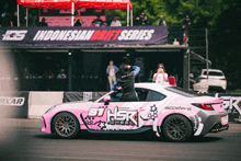 a pink and white car with the word hsr written on the side