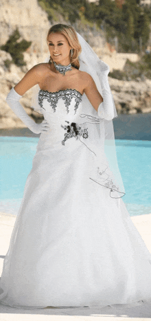 a woman in a white wedding dress with a black flower on it