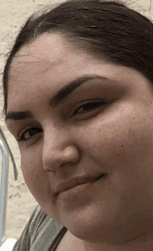 a close up of a woman 's face with freckles on it