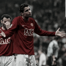 two soccer players wearing red aig jerseys are standing on a field