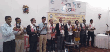 a group of people standing in front of a sign that says ' bangladesh '