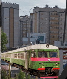 a green and white train with the letters 3t2m on the front