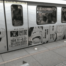 a subway car has an advertisement for one piece on it