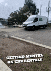 a white van is parked on the side of the road with the words " getting mental on the rental " below it