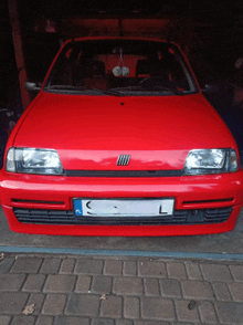 a red car with a license plate that says c and l