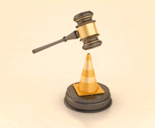 a judge 's gavel is sitting on top of a yellow traffic cone