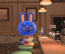 a blue bunny holding a cup of coffee in a cafe