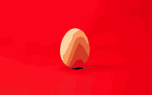 a brown egg is sitting on a red background