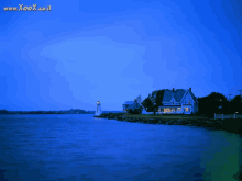 a lighthouse sits on a small island in the middle of a large body of water