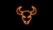 a bull 's head is glowing in the dark on a black background