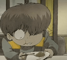 a cartoon boy is sitting at a table with a plate of food and a spoon in his mouth .