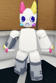 a white robot with a unicorn head and horns is standing on a black floor .