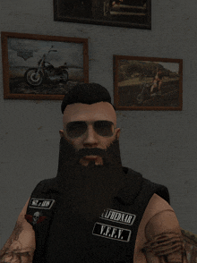 a man with a beard is wearing sunglasses and a vest that says ulfhednar