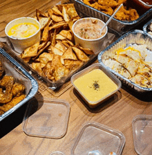 a table topped with a variety of food including a tray of chips