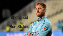 a man with a beard is standing with his arms crossed in front of a banner that says bhenchod ben stokes