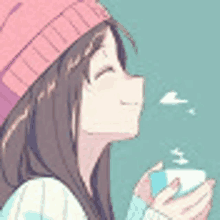 a girl in a pink hat is holding a cup of coffee in her hand .