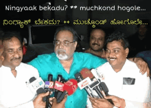 a group of men are standing in front of microphones with the words ningyaak bekadu muchkond hogole written above them