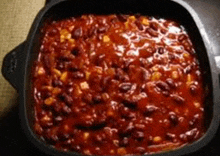 a bowl of chili with beans and corn in a sauce