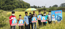 a group of people holding up signs with the number 2318 on them