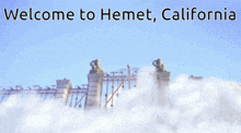 a sign that says welcome to hemet california with a gate in the background